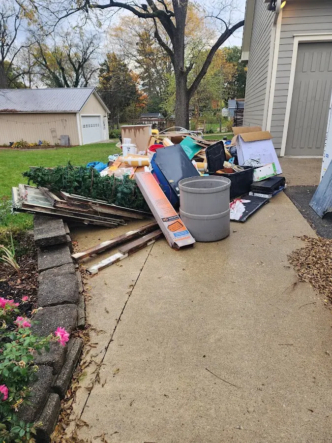 Dumpster being loaded with debris for 12 Yard Dumpster Rental in Addison